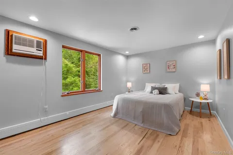 a bedroom with a large bed and a large window