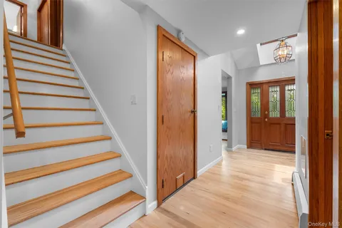 a view of a hallway with wooden floor and entryway