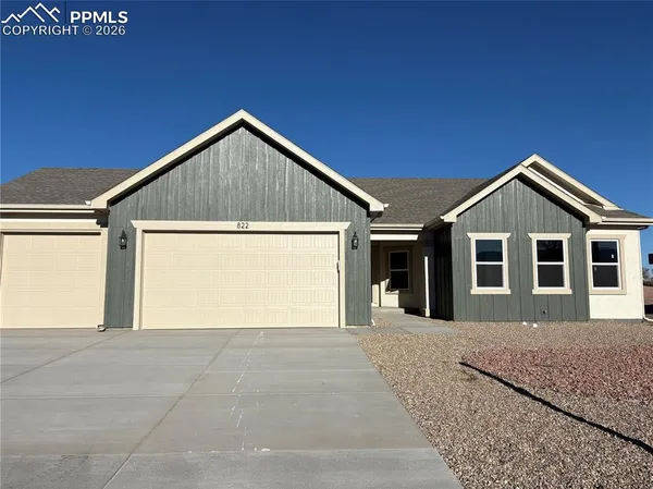 a view of a house with a yard and garage