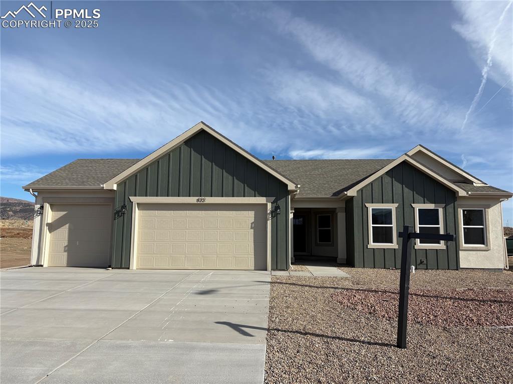 822 Keystone Loop Canon City, CO 81212 - Photo 14 of 14 a front view of a house with a yard and garage