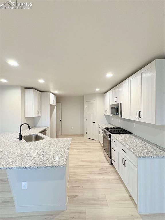 822 Keystone Loop Canon City, CO 81212 - Photo 2 of 14 a large kitchen with stainless steel appliances granite countertop a sink and a stove