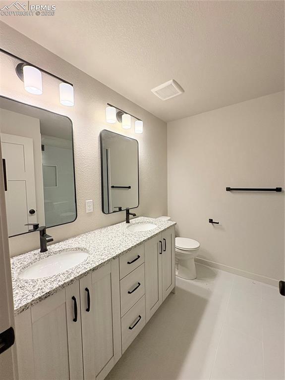 822 Keystone Loop Canon City, CO 81212 - Photo 4 of 14 a bathroom with a granite countertop sink mirror and toilet