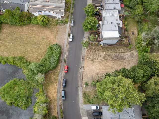 an aerial view of a house with a yard and garden