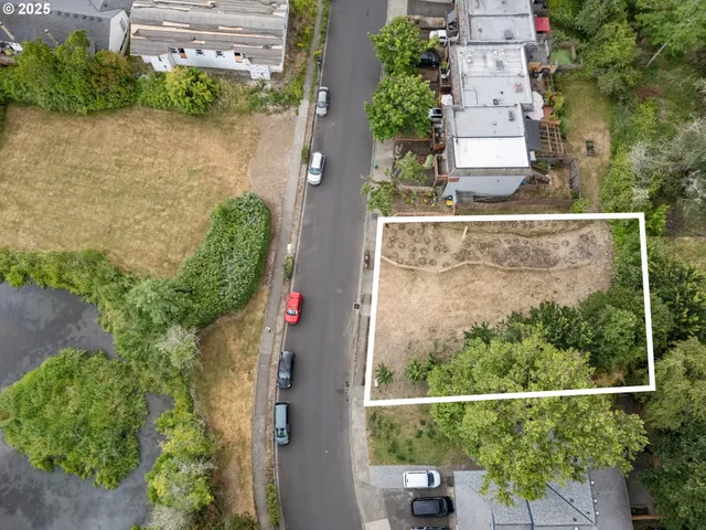 an aerial view of a house with a yard and outdoor seating