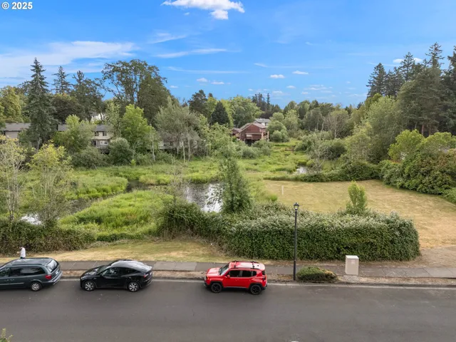 a view of car parked on road with city view