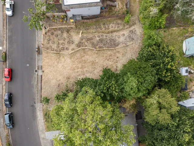 an aerial view of a house with a yard and garden