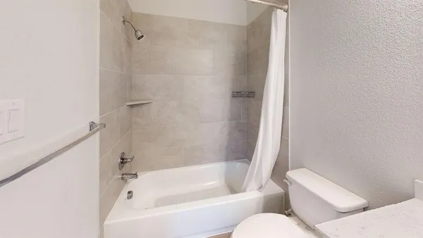 a white bath tub sitting next to a white toilet