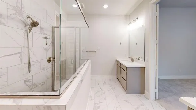 a bathroom with a double vanity sink a toilet and shower