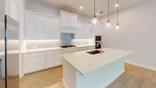 a kitchen with a sink a stove and a refrigerator