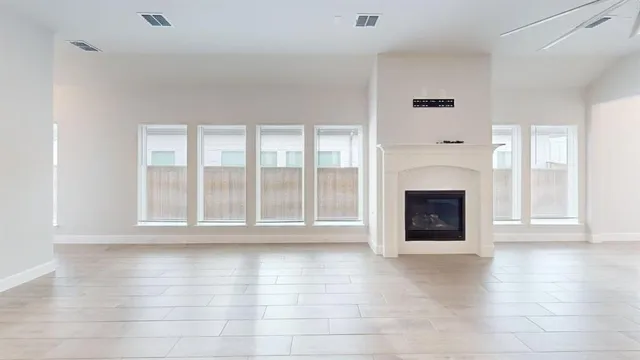 a view of a livingroom with a fireplace wooden floor and window