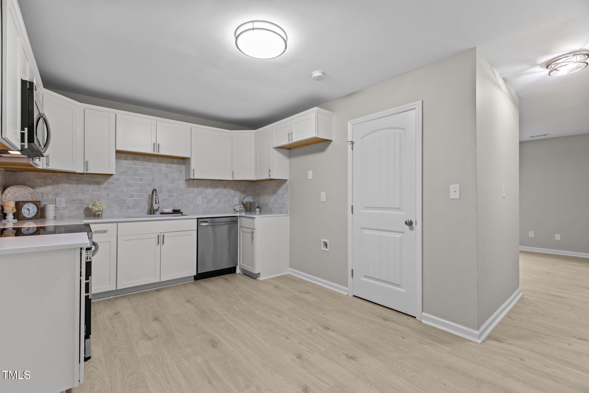 1433 Cherrycrest Drive Durham, NC 27704 - Photo 11 of 40 a kitchen with granite countertop white cabinets and white appliances
