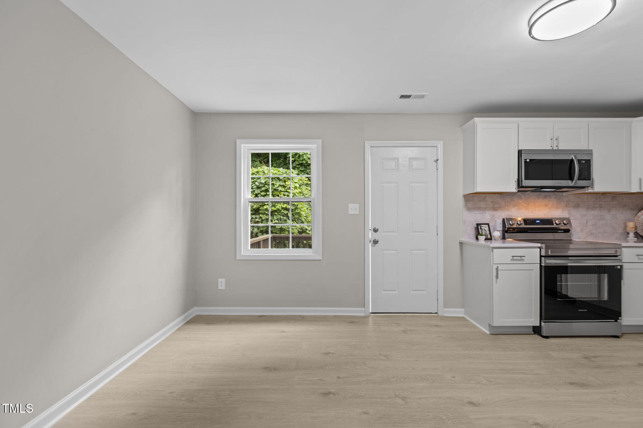1433 Cherrycrest Drive Durham, NC 27704 - Photo 12 of 40 a big room with windows and a fireplace
