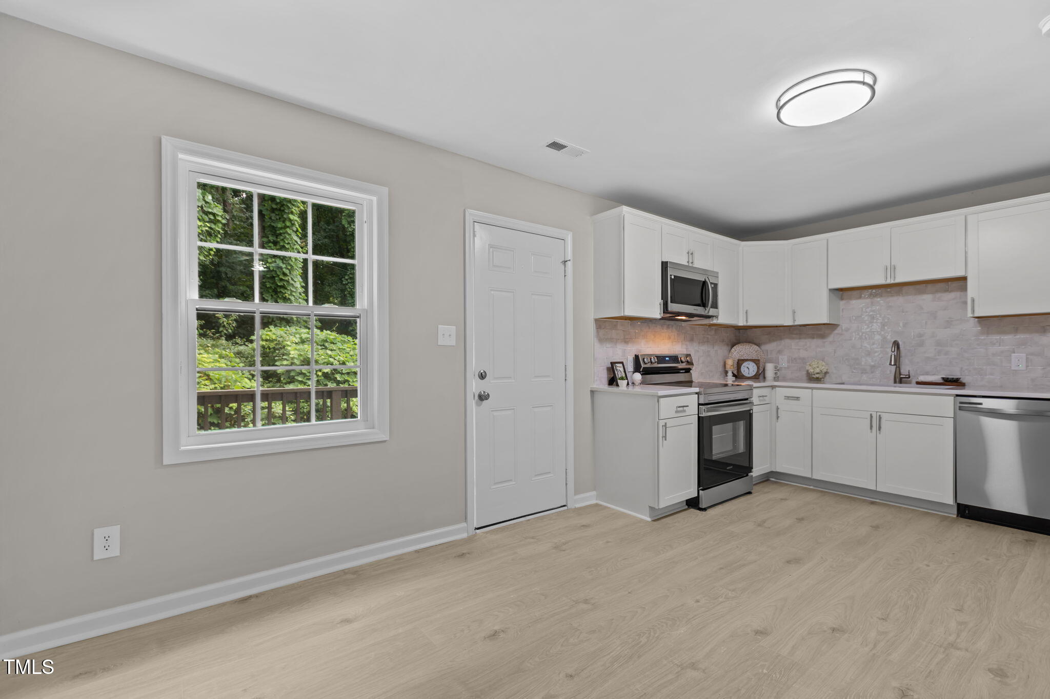 1433 Cherrycrest Drive Durham, NC 27704 - Photo 13 of 40 a kitchen with granite countertop white cabinets and white appliances
