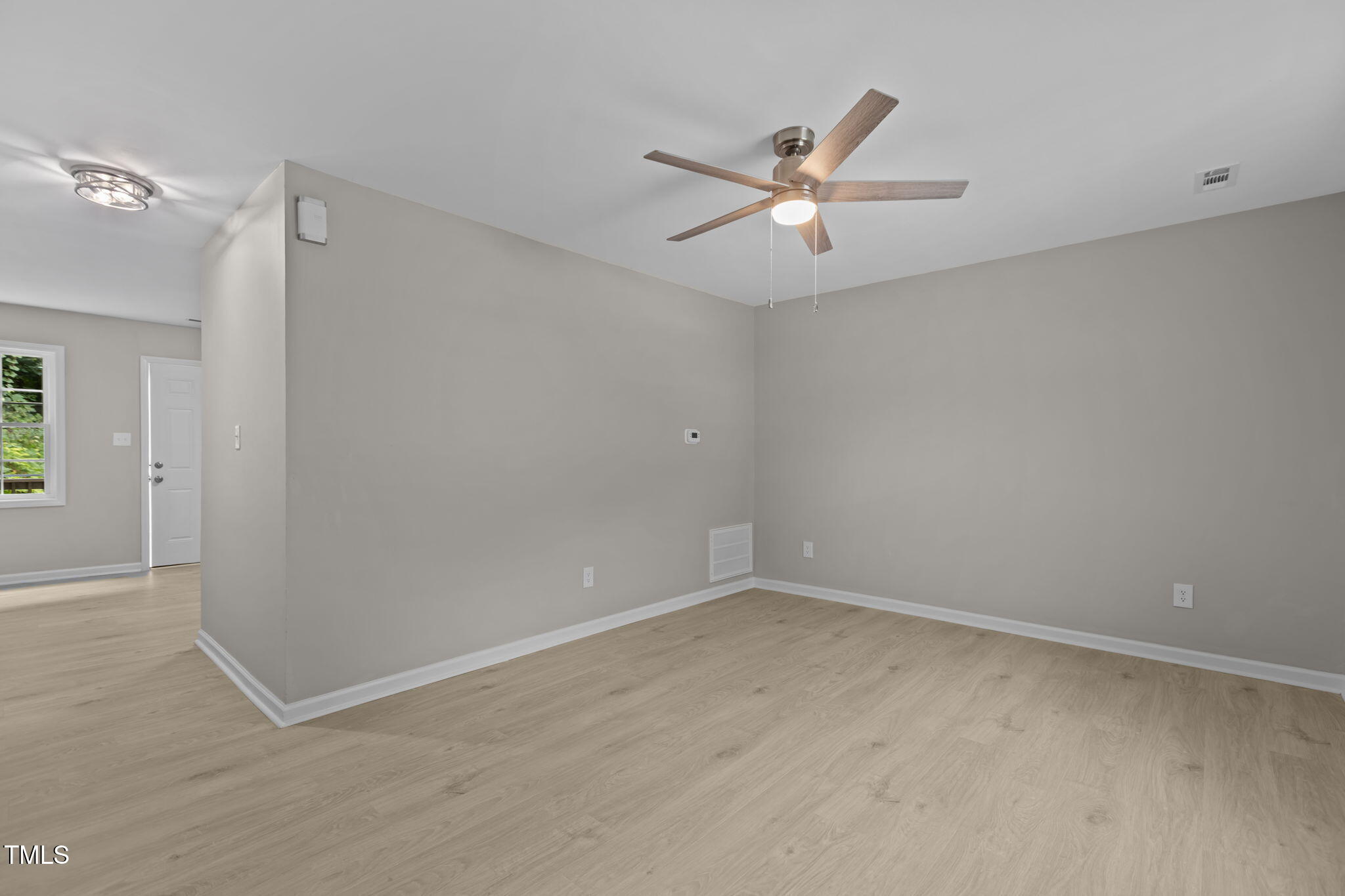 1433 Cherrycrest Drive Durham, NC 27704 - Photo 14 of 40 an empty room with windows and fan