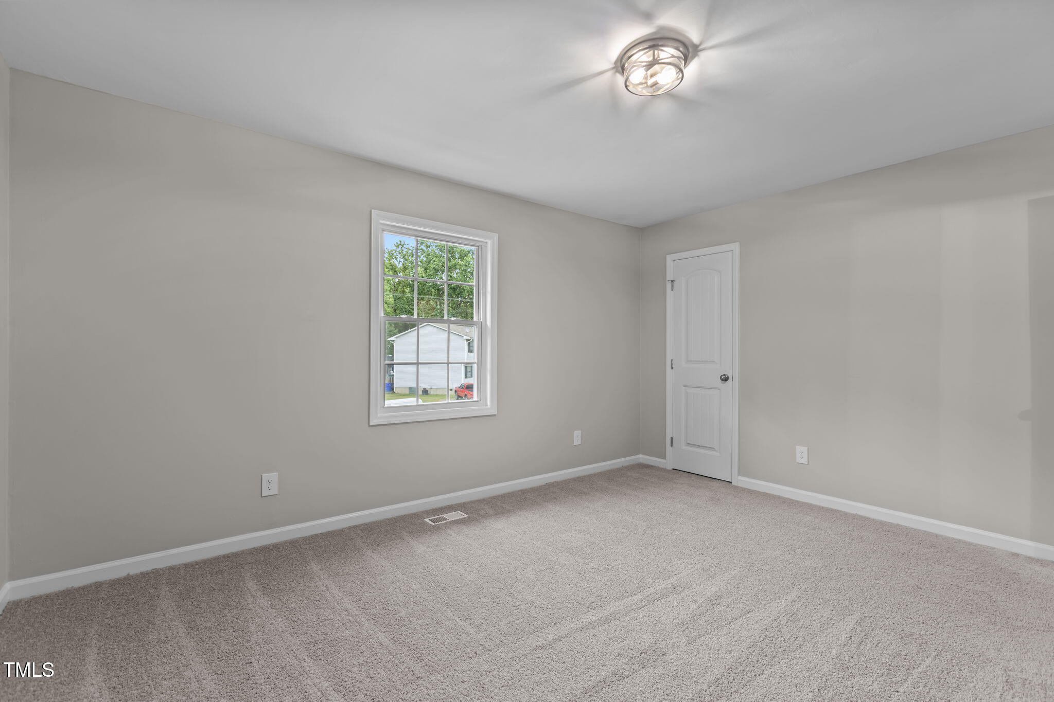 1433 Cherrycrest Drive Durham, NC 27704 - Photo 24 of 40 an empty room with a chandelier fan and windows
