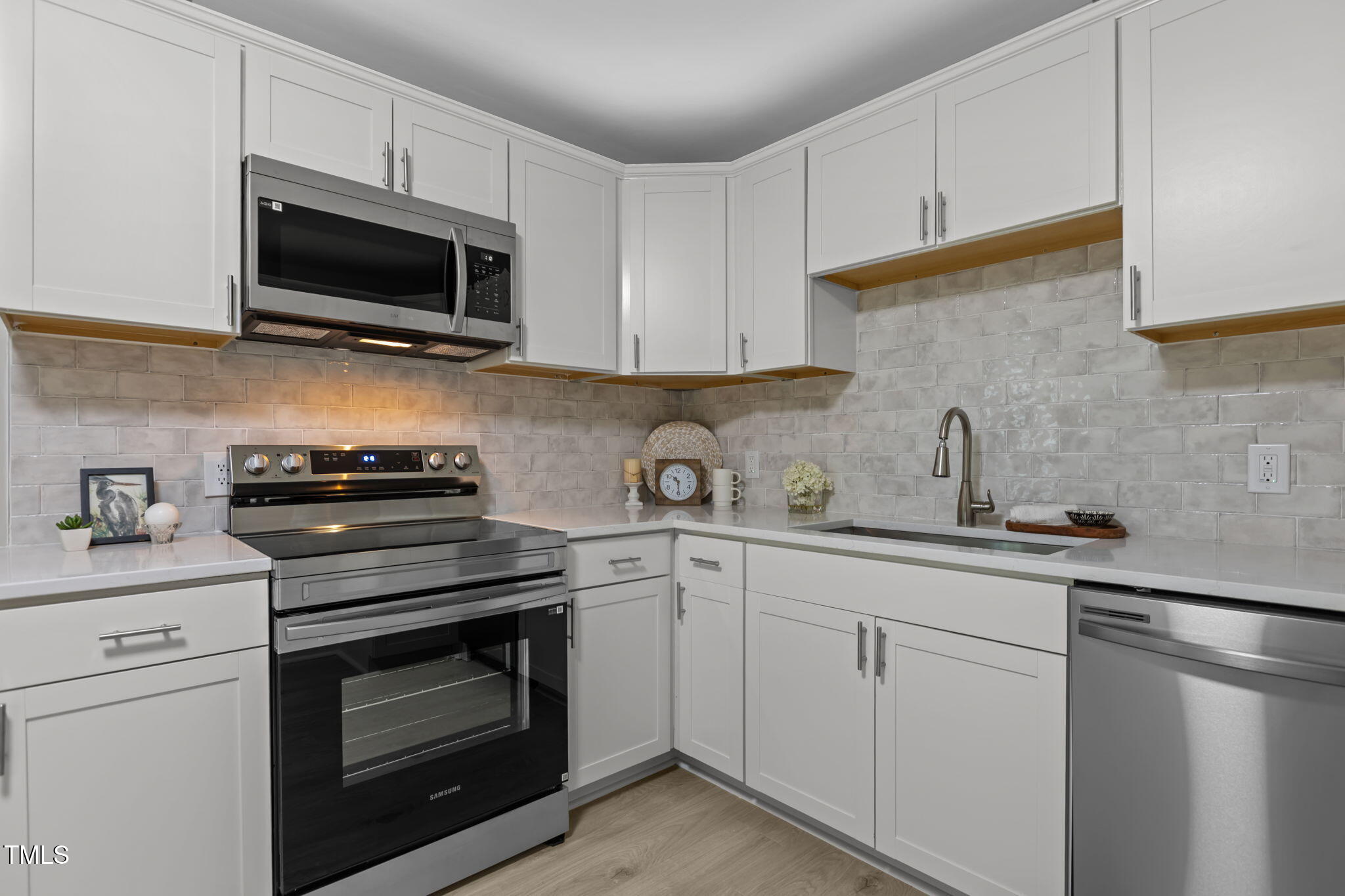 1433 Cherrycrest Drive Durham, NC 27704 - Photo 10 of 40 a kitchen with cabinets stainless steel appliances and a sink