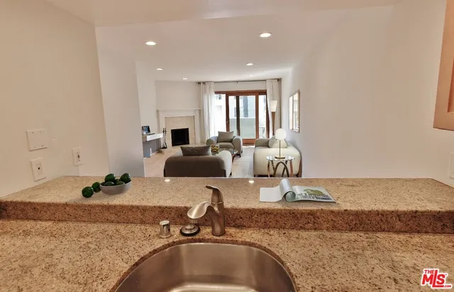 a view of a kitchen with granite countertop a sink and a counter top space