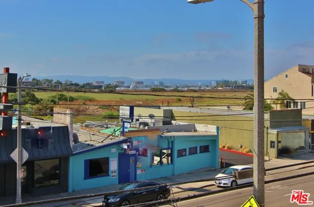 a view of hallway with wooden floor and door