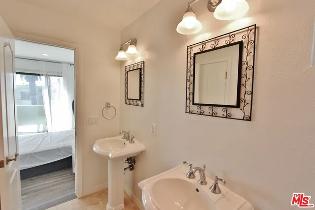 a bathroom with a bathtub shower sink and mirror