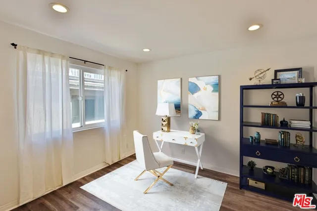 a view of a bedroom with wooden floor and closet