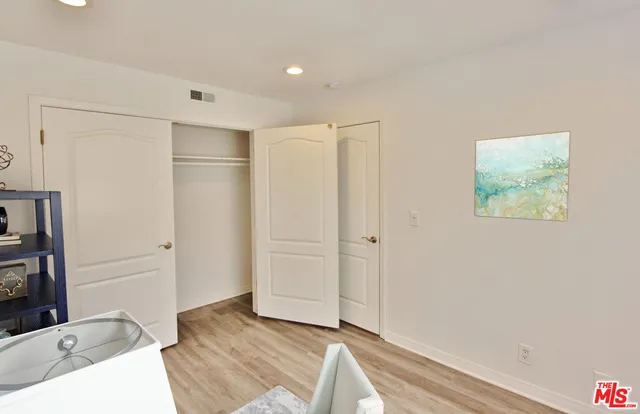 a view of a chair and table and potted on the side of building