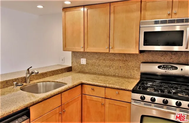 a kitchen with a sink stove and microwave
