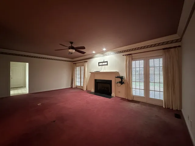 a view of empty room with a fireplace