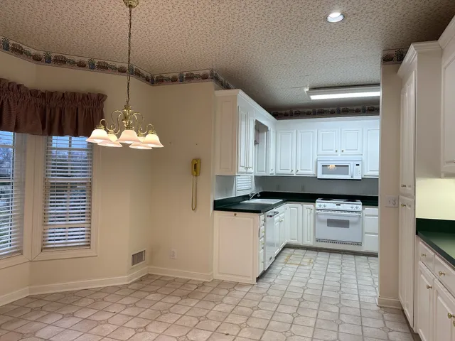 a room that has a window and a chandelier