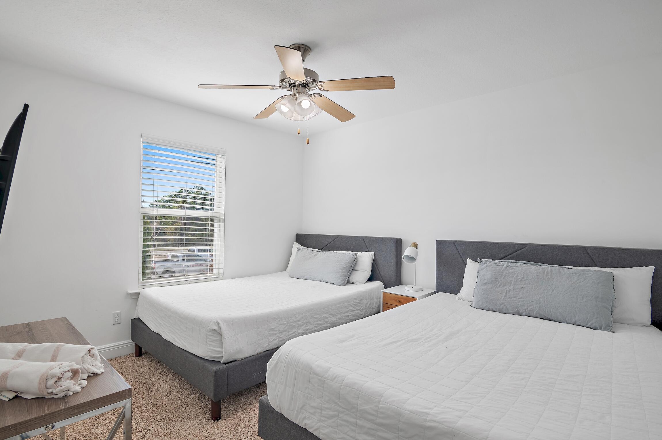 57 Grayling Way Inlet Beach, FL 32461 - Photo 6 of 8 a bedroom with two beds and a chandelier