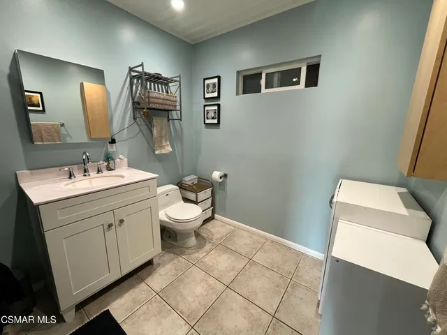 a bathroom with a sink mirror and toilet
