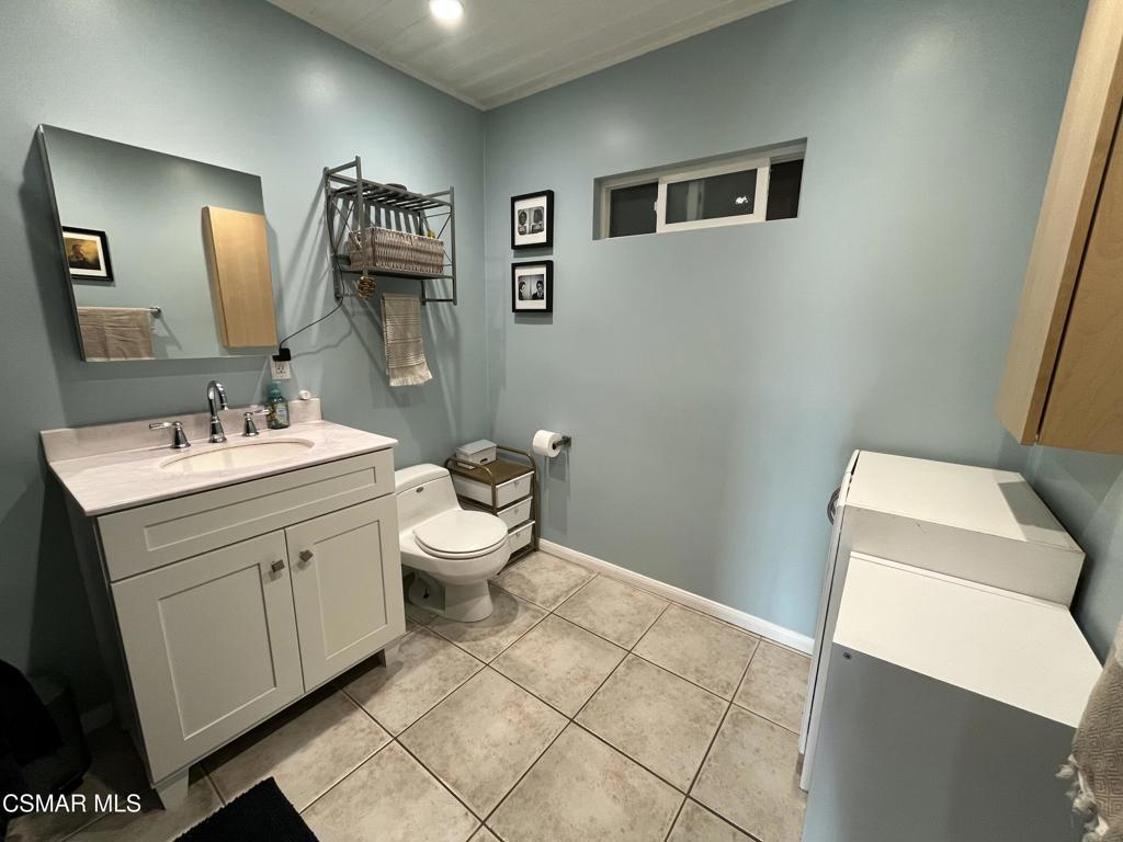 9333 Rowell Avenue Chatsworth, CA 91311 - Photo 13 of 25 a bathroom with a sink mirror and toilet