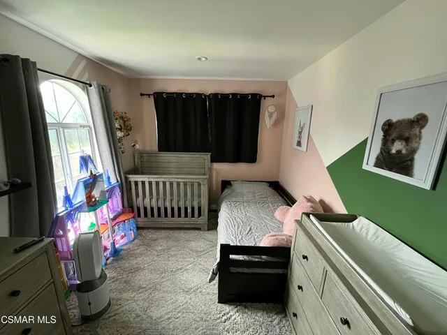 a bedroom with furniture and a window