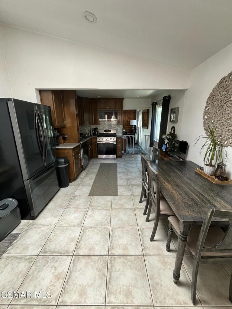 9333 Rowell Avenue Chatsworth, CA 91311 - Photo 4 of 25 a living room with furniture a flat screen tv and a table