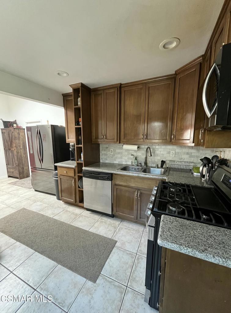 9333 Rowell Avenue Chatsworth, CA 91311 - Photo 5 of 25 a kitchen with a cabinets and appliances