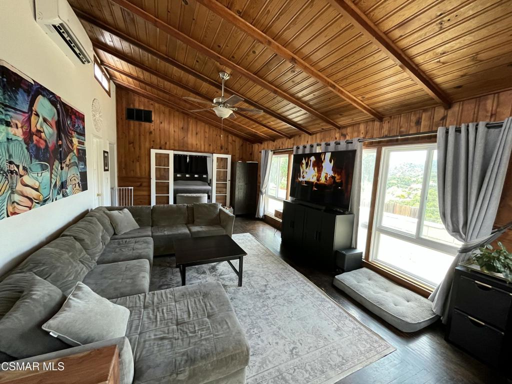 9333 Rowell Avenue Chatsworth, CA 91311 - Photo 6 of 25 a living room with furniture and a flat screen tv