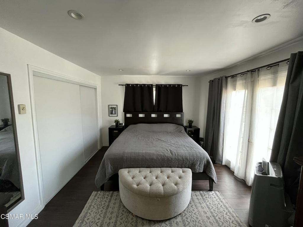 9333 Rowell Avenue Chatsworth, CA 91311 - Photo 9 of 25 a bedroom with a bed and wooden floor