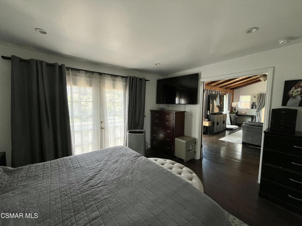 9333 Rowell Avenue Chatsworth, CA 91311 - Photo 10 of 25 a bedroom with a bed and wooden floor