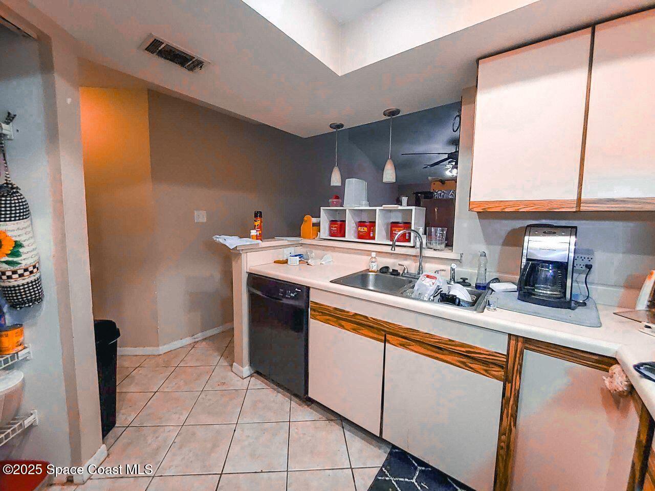 1515 Huntington Lane, Unit 628 Rockledge, FL 32955 - Photo 14 of 18 a kitchen with stainless steel appliances granite countertop a sink stove and cabinets