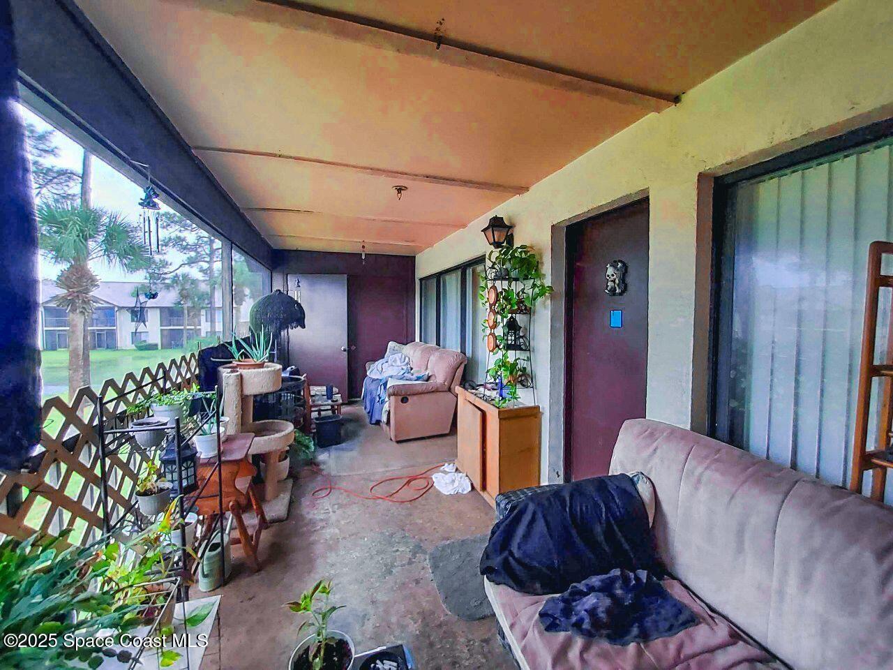 1515 Huntington Lane, Unit 628 Rockledge, FL 32955 - Photo 18 of 18 a living room with furniture a lamp and a potted plant