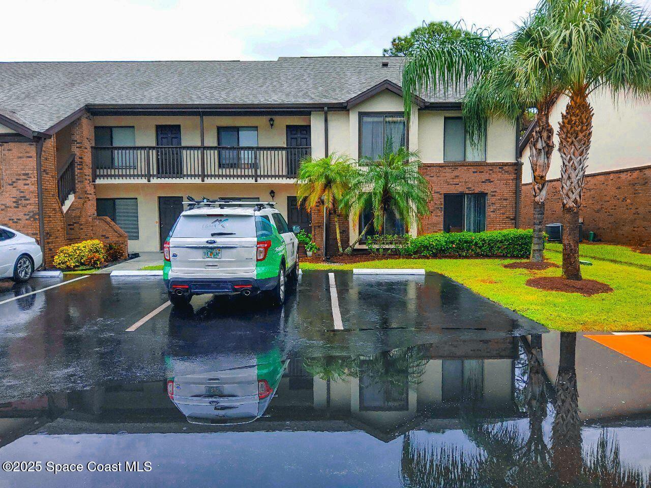 1515 Huntington Lane, Unit 628 Rockledge, FL 32955 - Photo 3 of 18 a front view of a house with garden