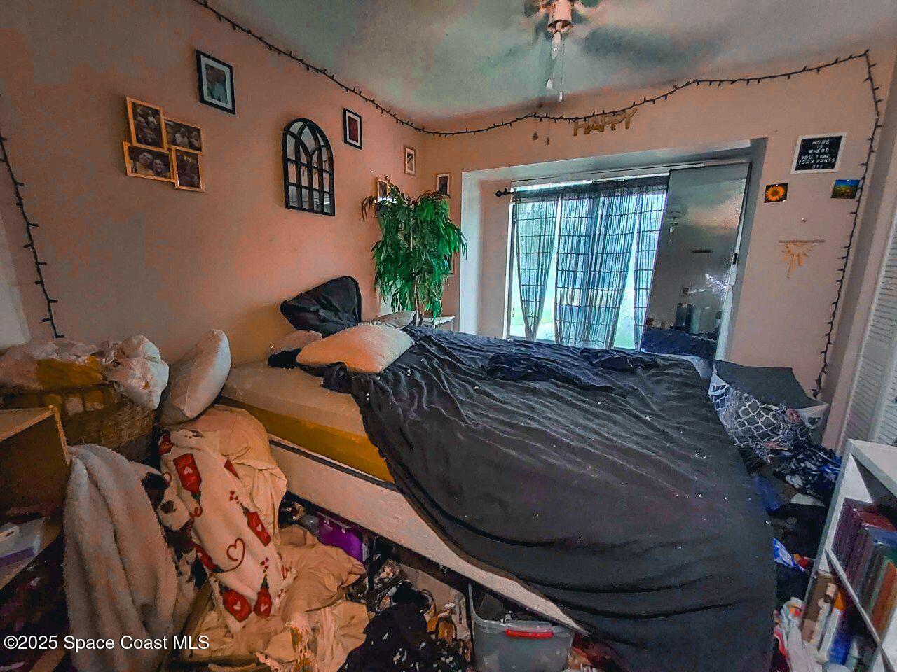 1515 Huntington Lane, Unit 628 Rockledge, FL 32955 - Photo 8 of 18 a large bed sitting in a bedroom next to a window