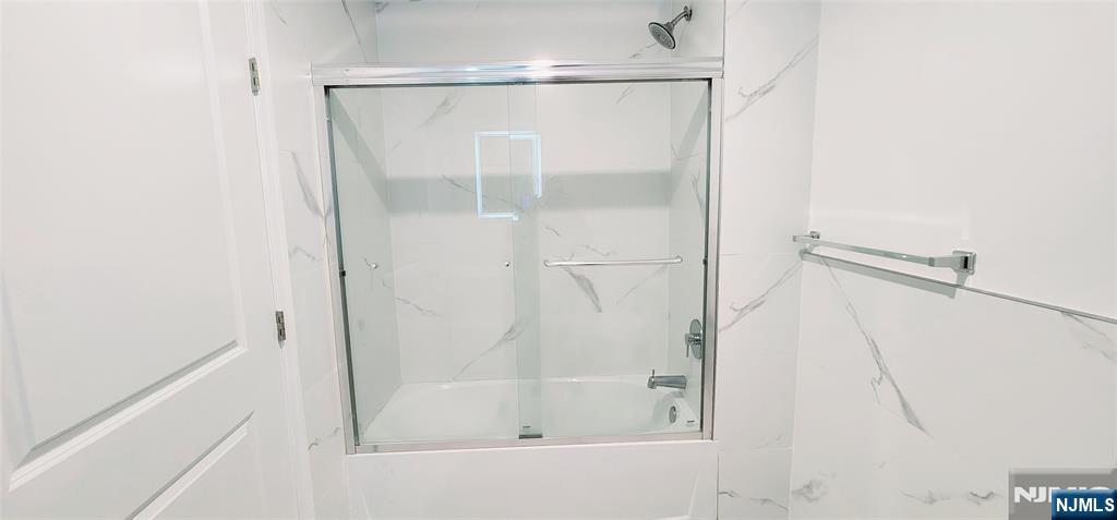 30 Howe Avenue, Unit 305 Passaic, NJ 07055 - Photo 5 of 5 a bathroom with a glass shower door