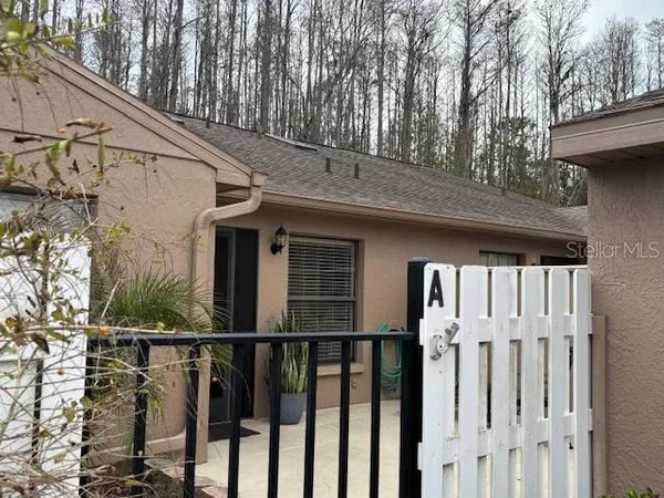 a view of a house with a wooden fence