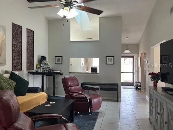 a living room with furniture and a chandelier