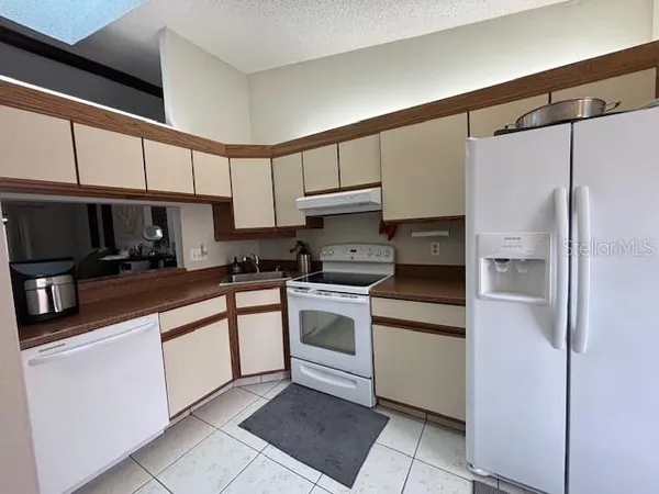a kitchen with cabinets and stainless steel appliances