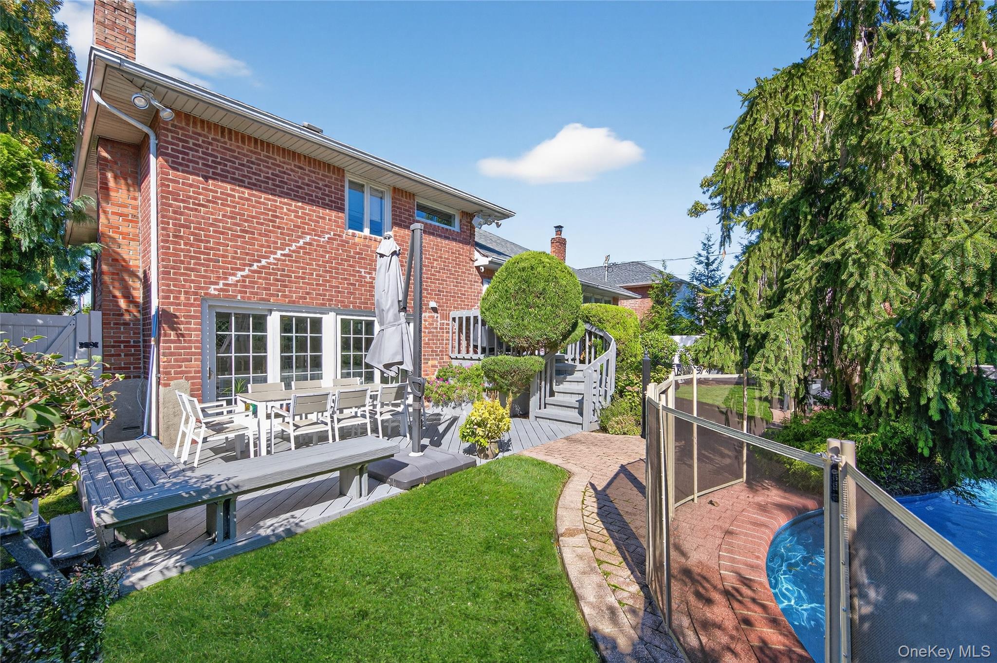 11 Sunbeam Road Syosset, NY 11791 - Photo 24 of 28 Backyard: In-ground heated saltwater swimming pool with patio and deck area