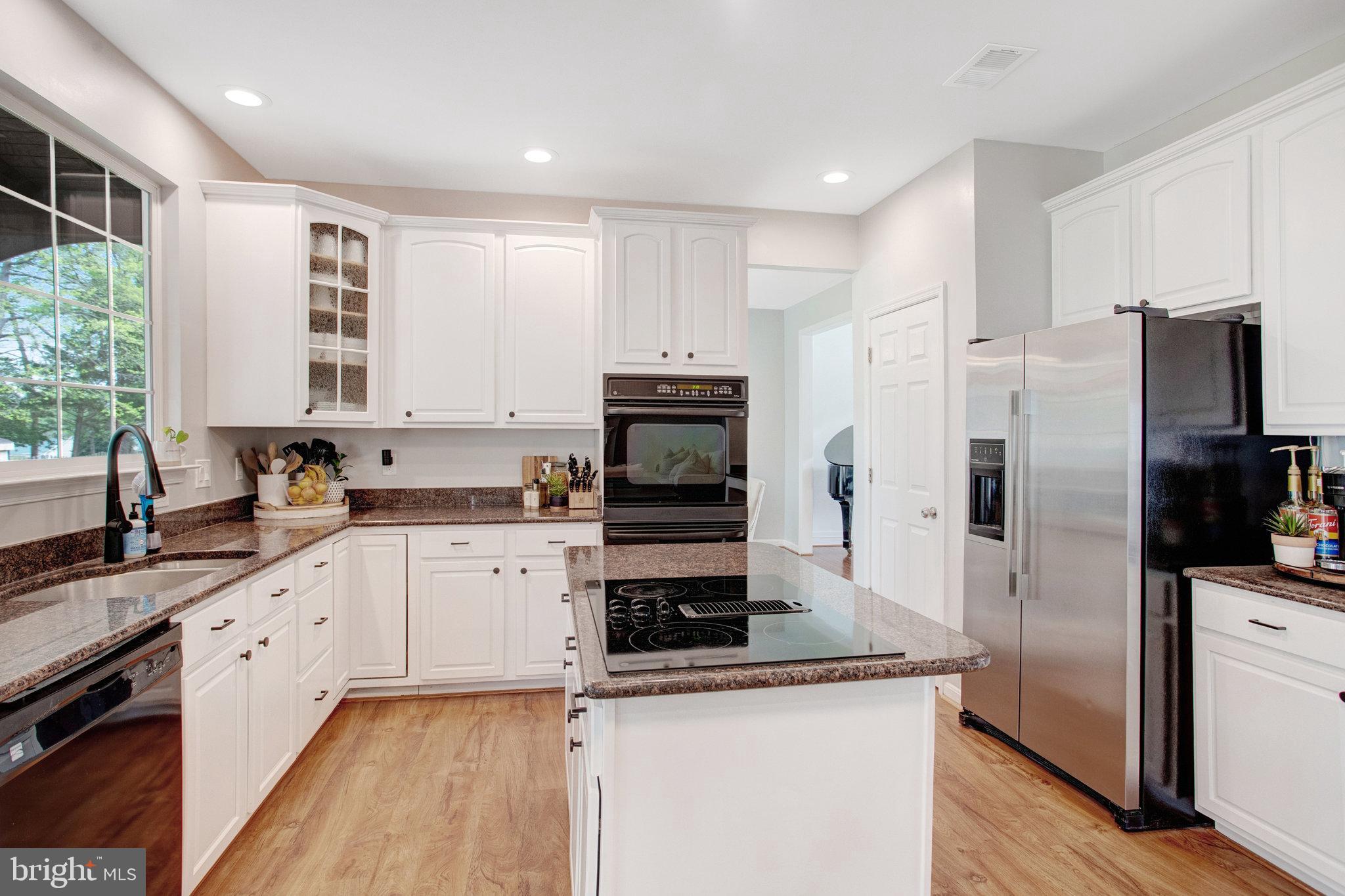 10375 Navarone Place Manassas, VA 20110 - Photo 11 of 51 a kitchen with a refrigerator sink and cabinets
