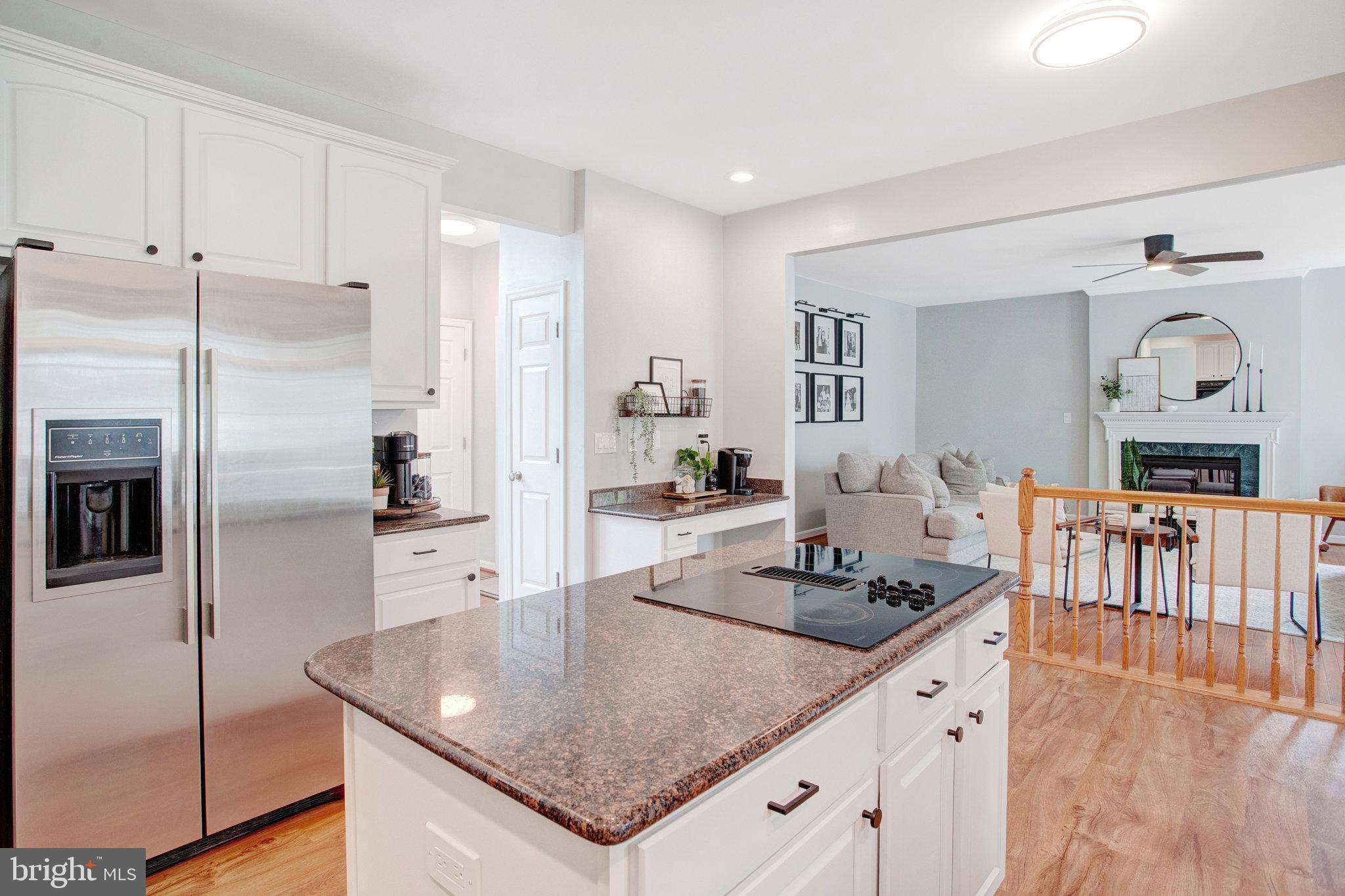 10375 Navarone Place Manassas, VA 20110 - Photo 12 of 51 a kitchen with stainless steel appliances granite countertop a sink a stove and refrigerator