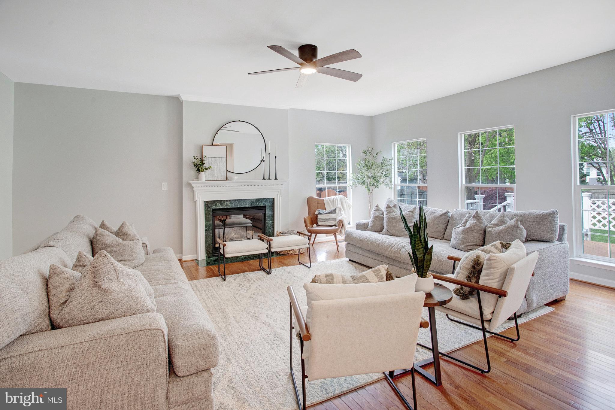 10375 Navarone Place Manassas, VA 20110 - Photo 14 of 51 a living room with furniture a fireplace and a floor to ceiling window