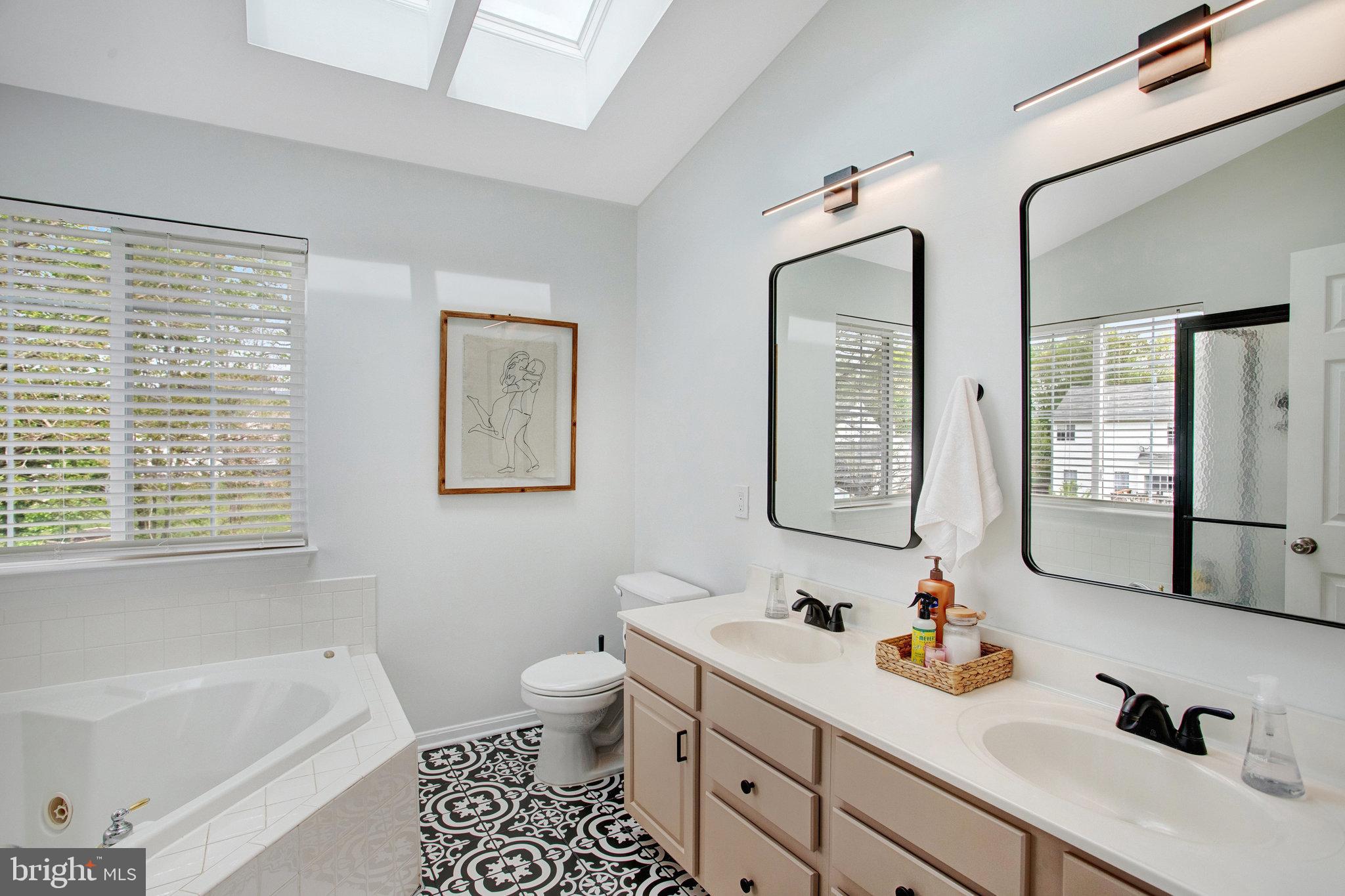 10375 Navarone Place Manassas, VA 20110 - Photo 22 of 51 a bathroom with a tub sink toilet and mirror
